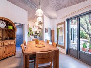 a dining room with a wooden table and chairs at Villa Villa Romana by Interhome in Porto-Vecchio +34 photos