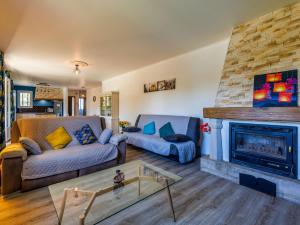 a living room with a couch and a fireplace at Holiday Home L'Aouzet by Interhome in Uzès +32 photos