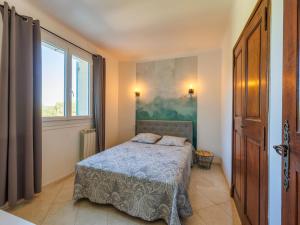a small bedroom with a bed and a window at Holiday Home L'Aouzet by Interhome in Uzès