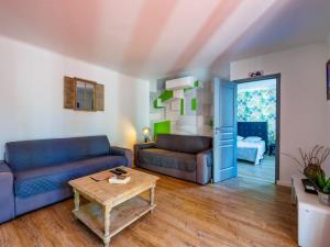 a living room with two couches and a coffee table at Holiday Home L'Aouzet by Interhome in Uzès