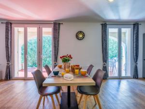 a dining room with a table and chairs at Holiday Home L'Aouzet by Interhome in Uzès +32 photos