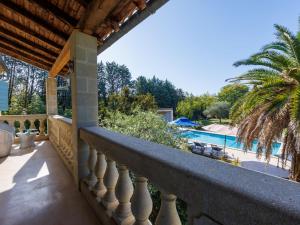 a balcony with a view of a swimming pool at Holiday Home L'Aouzet by Interhome in Uzès