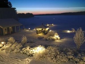 a view of a lake at night with lights at Holiday Home Villa keidas by Interhome in Pertunmaa