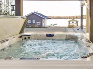 a jacuzzi tub in the backyard of a house at Holiday Home Villa keidas by Interhome in Pertunmaa