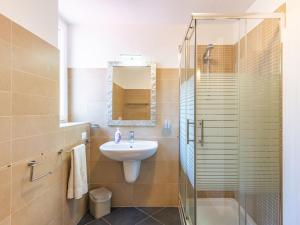 a bathroom with a sink and a shower at Apartment Baby by Interhome in Bellano