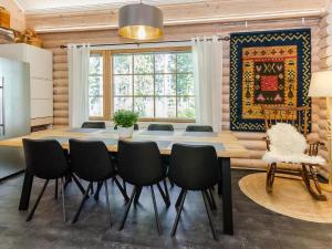 a dining room with a table and chairs at Holiday Home Villa usva by Interhome in Kolinkylä