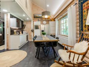 a kitchen and dining room with a table and chairs at Holiday Home Villa usva by Interhome in Kolinkylä