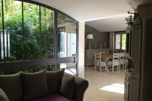 a living room with a couch and a dining room at Villa Maya in Puget