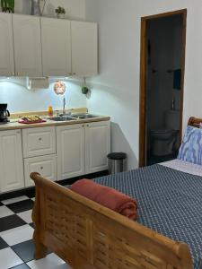 a kitchen with a bed and a sink at 310Guest-House La Vyda in San Juan