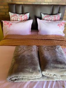 a bed with two pillows on top of it at Good Life Guest house in Orkney +27731671754 in Orkney