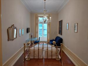 a living room with a staircase and a mirror at Chiado apartments in Lisbon