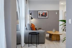 a living room with a couch and a table at MAD Apartments by Olala Homes in Madrid