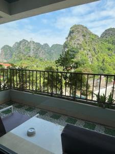a room with a balcony with a view of mountains at Limestone View Homestay in Ninh Binh