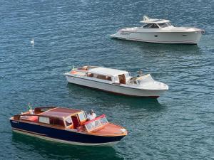 two boats in the water next to each other at Al Molo 5 - Lake Front in Oliveto Lario