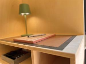 a desk with a notebook and a lamp on it at Tiny House zwischen Berlin und Potsdam in Berlin