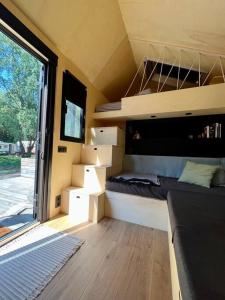 a small room with a bed in a tiny house at Tiny House zwischen Berlin und Potsdam in Berlin