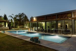 a house with a swimming pool in front of it at Quinta do Eden in Vagos