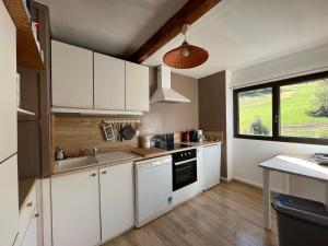 una pequeña cocina con armarios blancos y una ventana en Appartement Enchastrayes, 2 pièces, 9 personnes - FR-1-165A-103 en Enchastrayes