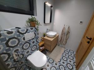 a bathroom with a sink and a toilet in it at CHALUPY TRI GROŠE VLAŠKY in Bešeňová +51 photos