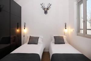 Ένα ή περισσότερα κρεβάτια σε δωμάτιο στο Appartement Paris by La Boîte En Plus