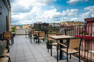 a patio with tables and chairs on a balcony at Hotel Atari in Donostia-San Sebastián