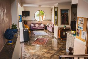 a living room with a couch and a table at Hotel Alexander in Giardini Naxos