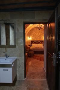 a bathroom with a sink and a bed in a room at Stone Owl Otel & Restaurant in Uchisar +126 photos