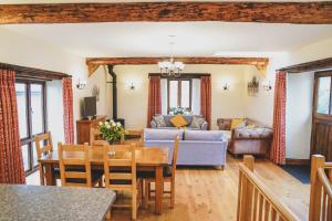 a living room with a couch and a table at Hawley Farm in Hawley Bottom