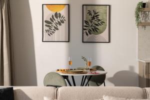Sala de estar con mesa y 3 cuadros en la pared en Kaya Apartments Kalamar, en Kalkan