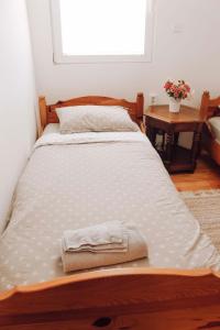 a bed with two towels on it in a room at Weekend Joy Home Visoko in Visoko