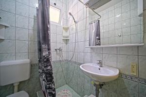 a bathroom with a shower and a sink and a toilet at Apartments Villa Marija in Podobuče +31 photos