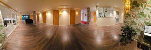 a hallway with a wooden floor in a building at Hotel City Living in Stockholm