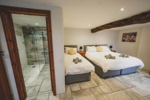 a bedroom with two beds and a walk in shower at Hawley Farm in Hawley Bottom