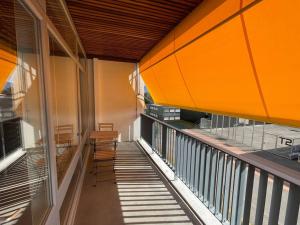a balcony of a building with chairs on it at Wide, bright and quiet loft in Geneva
