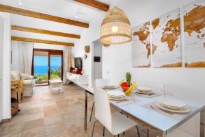 a dining room and living room with a table and chairs at Villa Giorgia - Costa Paradiso in Costa Paradiso