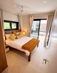 a bedroom with a bed and a large window at Fajara Residence in Fajara