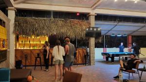 a group of people standing in a room with a pool table at Ha Giang Lotus Hostel Motorbikes and Tours in Ha Giang