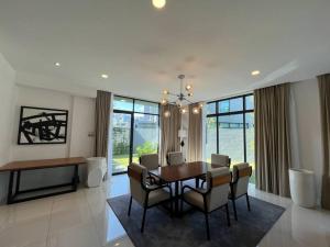 a dining room with a table and chairs at La Mer Luxury Private Pool Villa in Pantai Cenang