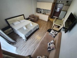 a large bedroom with a bed and a couch at Orbi Royal Apartments in Batumi