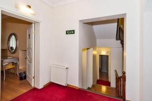 a hallway with a red rug and a mirror at Hotel Santa Hill in Istanbul