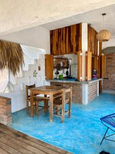 a dining room with a wooden table and chairs at Casa Aquila Mazunte in Mazunte