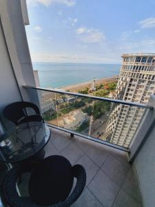 a balcony with a view of the ocean from a building at Royal Apartments Batumi in Batumi