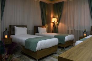a hotel room with two beds and a lamp at Cibali Hotel Istanbul in Istanbul