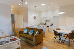 a living room and kitchen with a couch and a table at WENSLEYDALE, OLD SCHOOL ROOMS - Ground Floor Luxury Apartment in Richmond, North Yorkshire in Richmond