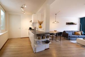 a kitchen and living room with a table and a couch at Hermanus Boexstraat in Eindhoven