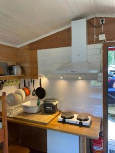 a kitchen with a counter top with a stove at Langenuen Motel & Camping in Stord