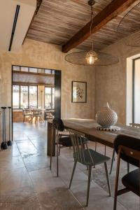 a dining room with a large wooden table and chairs at LA BASTIDE DES CULS-ROUSSET in Marseille