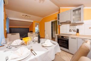 a kitchen with a table with a white table cloth at Apartment Davor in Dramalj