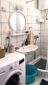 a bathroom with a washing machine and a sink at Apartments Rosa in Kaprije