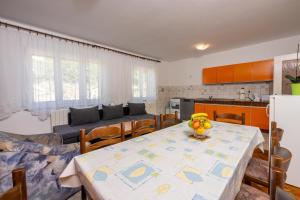 a kitchen and dining room with a table with bananas on it at Apartments Antonio in Crikvenica